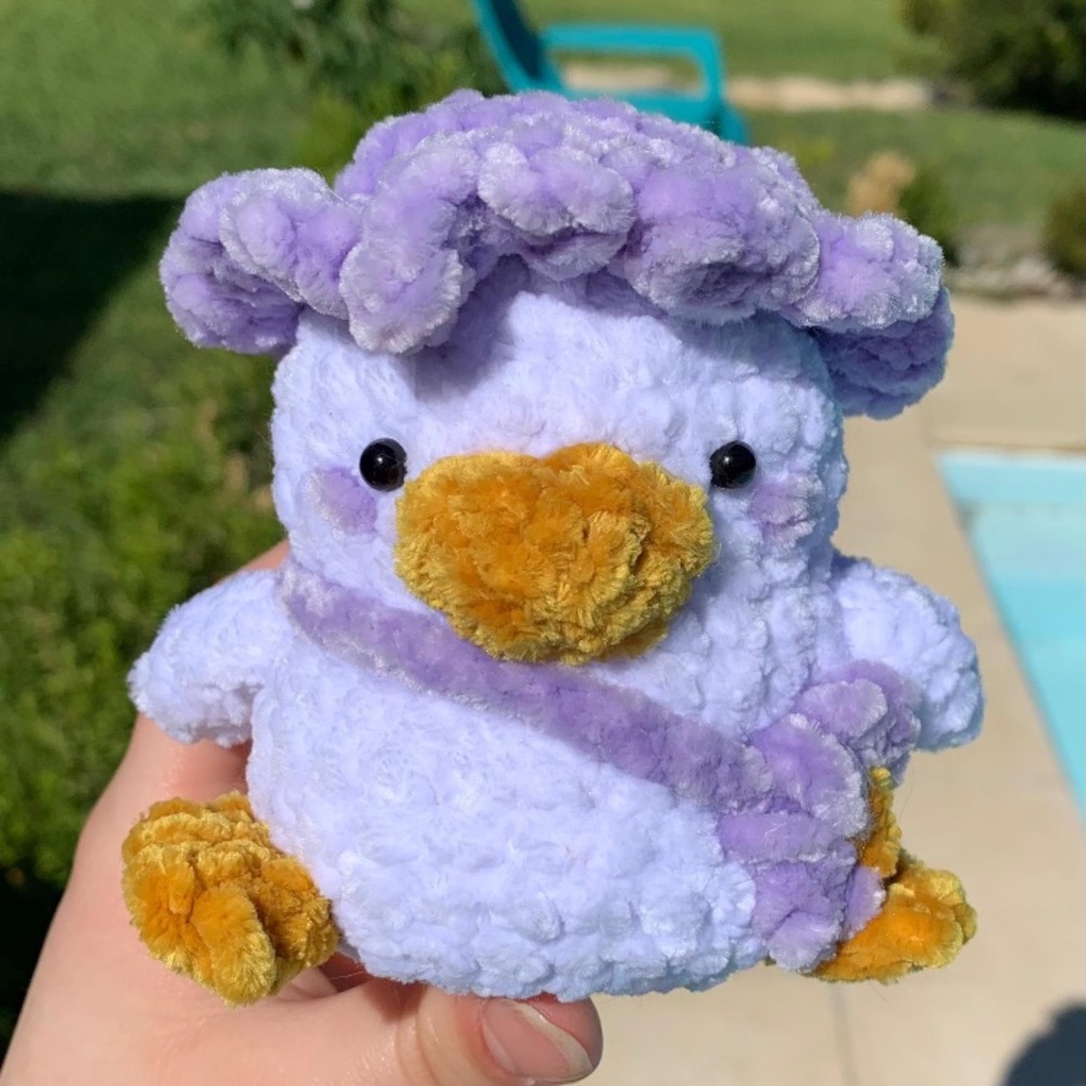 Handmade Crocheted white duck with purple bonnet.